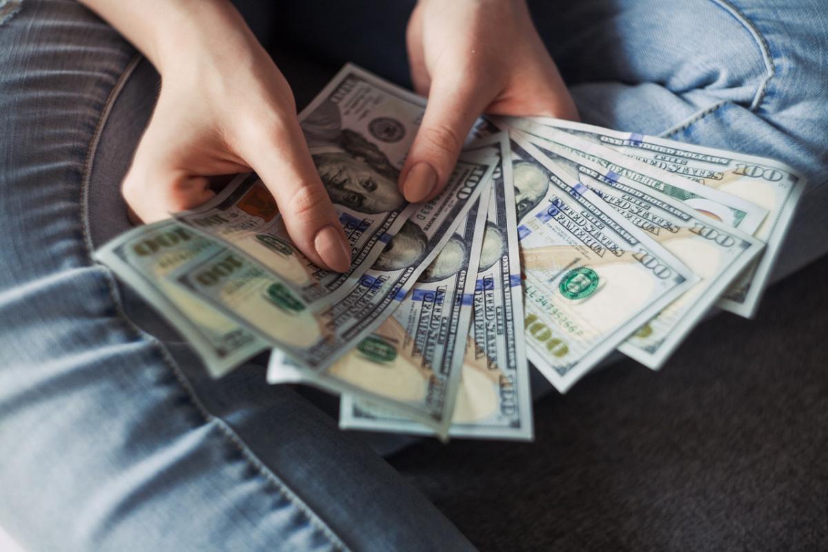 Person fanning cash in their hands